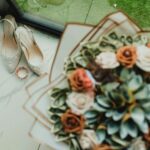 Elegant bridal shoes and a bouquet with succulents perfect for a stylish wedding.