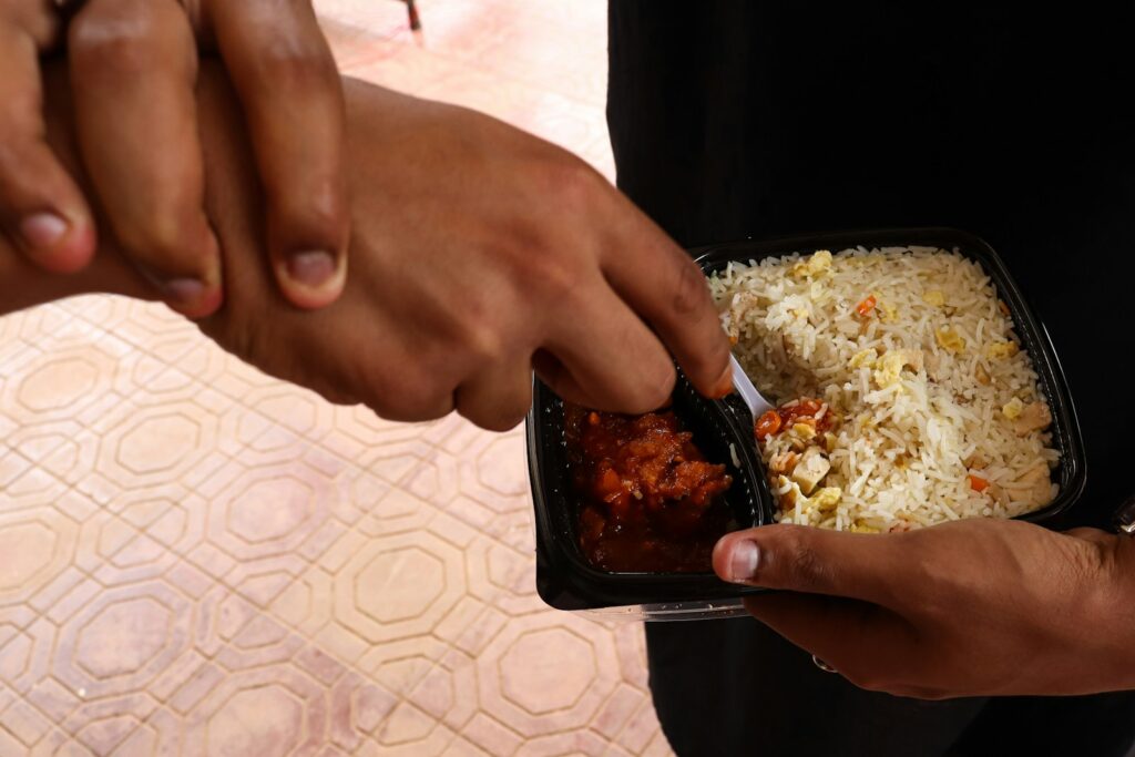 A couple of people that are holding some food