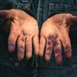 Hands covered in purple ink.