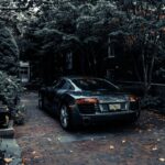 A sleek Audi R8 parked in a leafy residential driveway in Cape May, NJ, showcasing elegance and luxury.