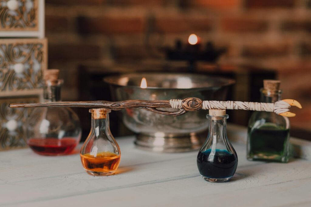 Enchanting still life featuring glass potion bottles and a crafted magic wand.
