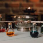 Enchanting still life featuring glass potion bottles and a crafted magic wand.