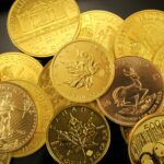 A detailed close-up of diverse gold bullion coins from different countries.