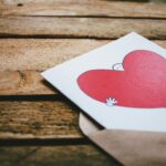A charming heart illustration on a card inside an envelope placed on a rustic wooden table, perfect for Valentine's Day.