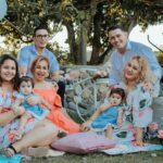 A joyful family enjoying an outdoor gathering in La Dorada, Colombia, surrounded by colorful decor.