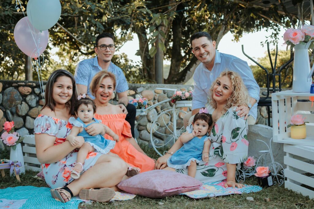 A joyful family enjoying an outdoor gathering in La Dorada, Colombia, surrounded by colorful decor.