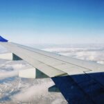 A stunning aerial view of clouds and landscape from an airplane window above Kazakhstan.