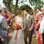 Couple celebrates outdoor wedding in England with family and friends.
