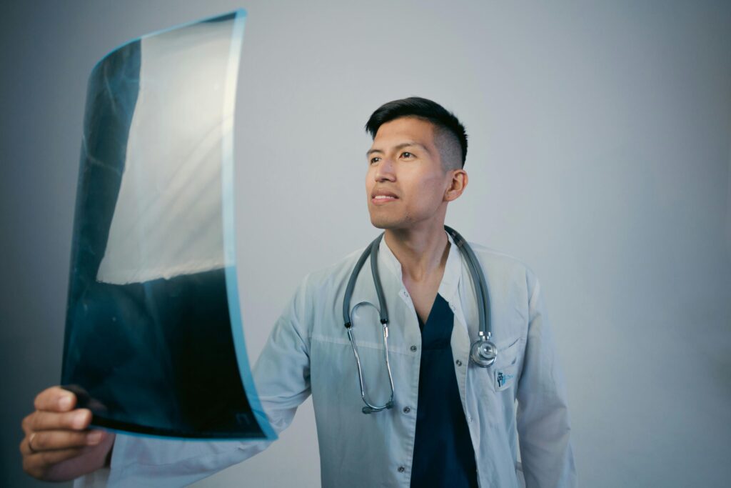 Doctor analyzing X-ray film confidently in a clinical setting.