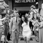 Lively outdoor wedding ceremony in Romania with happy couple and guests.