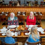 Multi-generational family enjoying a festive meal together at a restaurant in Dubai.