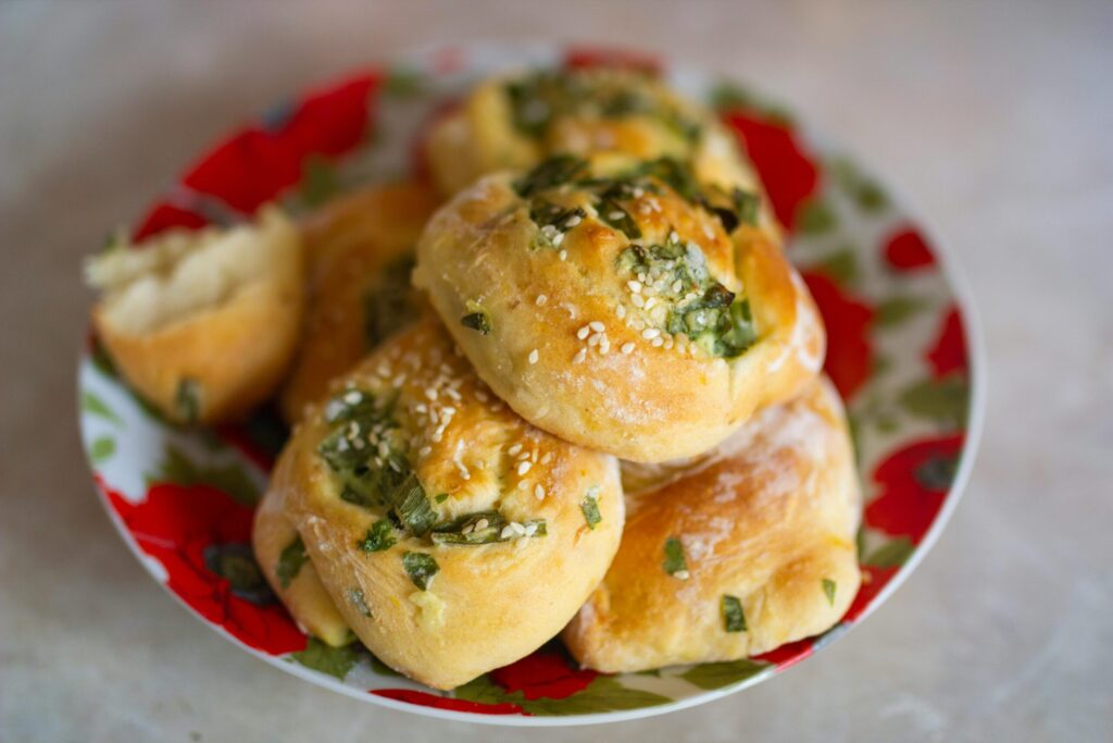 Delicious sesame and herb rolls on a colorful plate, perfect for a tasty snack or meal.