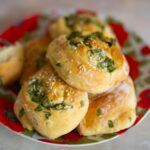Delicious sesame and herb rolls on a colorful plate, perfect for a tasty snack or meal.