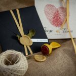 Stylish wedding invitation featuring black envelope, wax seal, and personalized card. Perfect for elegant occasions.