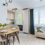 Bright kitchen with dining area in Scandinavian style, featuring minimalist design.