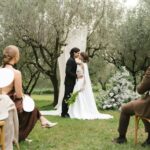 A beautiful outdoor wedding ceremony in Torroella de Montgrí, Spain with the couple and guests.