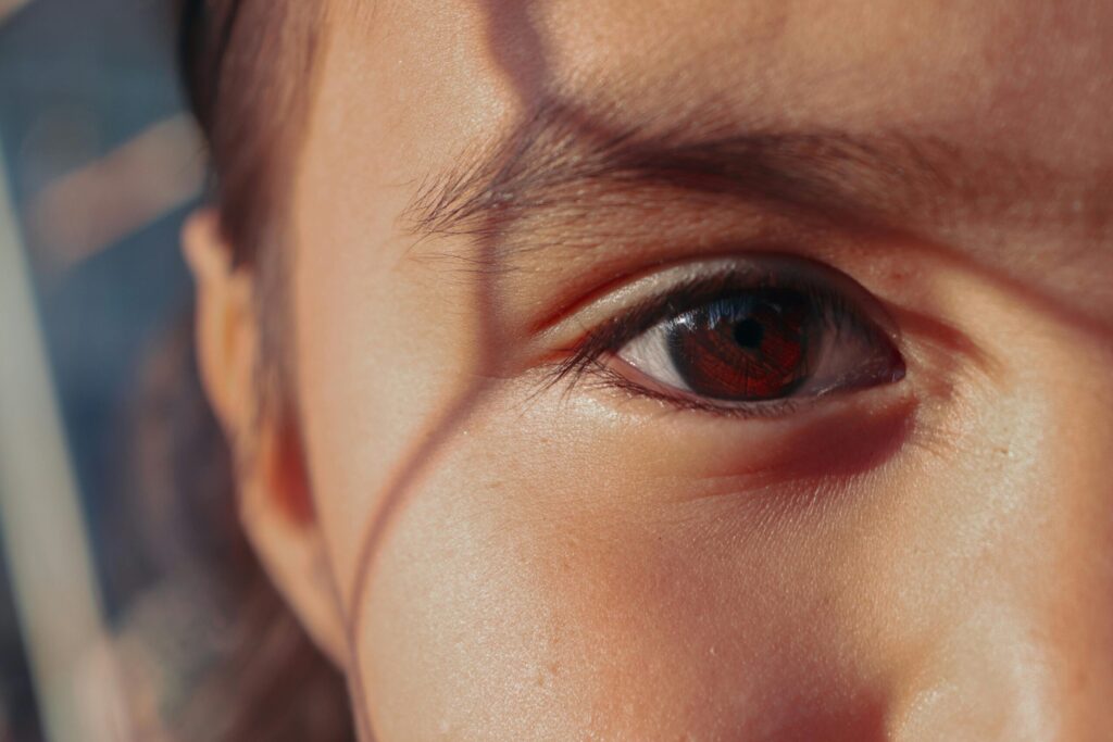 A detailed close-up of a child's eye with soft shadows, radiating warmth.