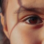 A detailed close-up of a child's eye with soft shadows, radiating warmth.