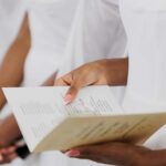 Close-up of a woman's hands holding a wedding ceremony program.