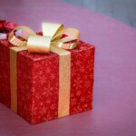Elegant red gift box with gold ribbon, perfect for Christmas celebrations and holiday gifting.