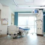 A well-equipped hospital room with a bed and advanced medical equipment.